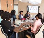 Diverse team engaging in a productive business meeting in a modern office setting.